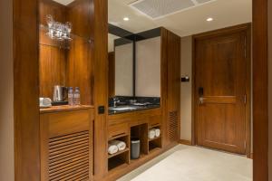 a bathroom with a sink and a wooden cabinet at Swiss Residence Kandy in Kandy