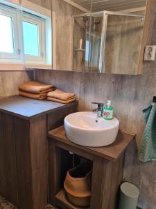 a bathroom with a sink and a mirror at Nordfjordcabins BLUE in Utvik +39 photos