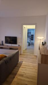 a living room with a couch and a flat screen tv at Bandìtella home in Livorno
