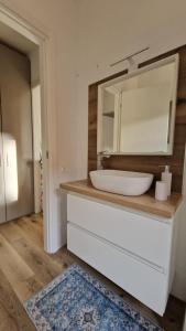 a bathroom with a sink and a mirror at Bandìtella home in Livorno