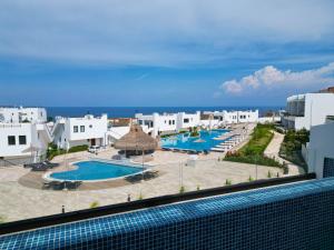 a view of a resort with two swimming pools at Mykonos Holiday Homes in Kyrenia