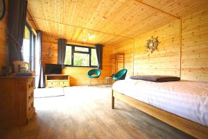 a bedroom with a bed in a wooden room at Paull Holme Farm Bed and Breakfast in Paull