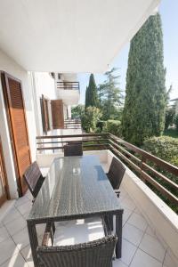 a patio with a table and chairs on a balcony at Residence Alexandra Stay in Sirmione