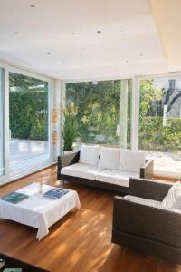 a living room with a couch and a table at Residence Alexandra Stay in Sirmione +41 photos
