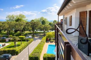 a balcony with a view of a street and a pool at Residence Alexandra Stay in Sirmione