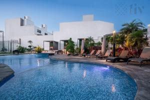 a swimming pool in front of a building at Apartment home resort in La Cañada