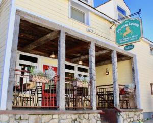 a restaurant with tables and chairs in front of a building at Above Mustang Condos in Mackinac Island