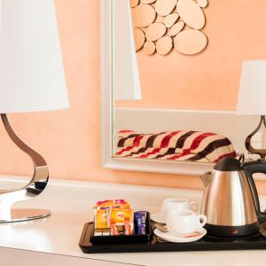 a table with a lamp and a tray with food and drinks at Hotel Aguado in Dieppe