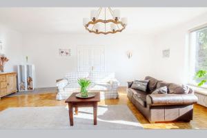 a living room with a couch and a table at White Villa in Baden