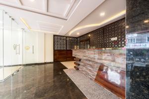 a lobby with a wall of wine bottles at Treebo Trend Greenwood Premier Suites Old Airport Road in Bangalore