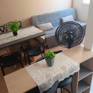 a living room with two tables and a couch at MaM TORRE DOS HOLANDESES in São Luís