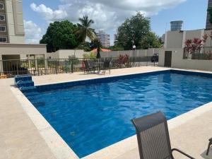 a swimming pool with blue water in a building at MaM TORRE DOS HOLANDESES in São Luís