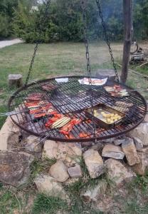 a barbecue grill with food on a swing set at Podere Lama in Castelnuovo di Val di Cecina