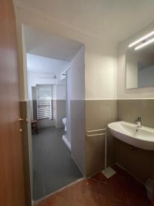 a bathroom with a sink and a toilet at Casa per la Pace in Impruneta