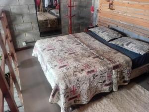 a bed with a quilt on it in a room at Villa Madalena Lofts in Maceió