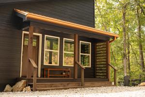 a screened in porch of a cabin with windows at Dual-Head Shower for Two-Romantic Retreat in Aerial