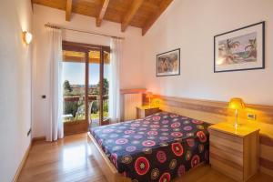 a bedroom with a bed and a large window at Casa Flora in Garda
