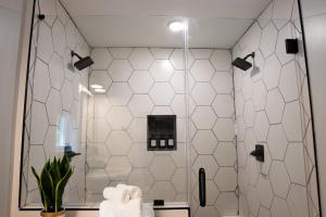 a bathroom with a shower with white tiles at Dual-Head Shower for Two-Romantic Retreat in Aerial +32 photos