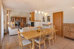 a kitchen and dining room with a wooden table and chairs at Casa Flora in Garda