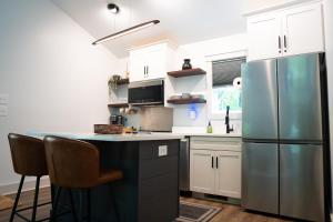 a kitchen with white cabinets and a refrigerator at Dual-Head Shower for Two-Romantic Retreat in Aerial