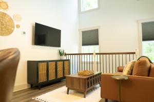 a living room with a couch and a tv at Dual-Head Shower for Two-Romantic Retreat in Aerial