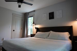 a bedroom with a large bed with a ceiling fan at Dual-Head Shower for Two-Romantic Retreat in Aerial