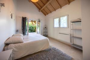 a bedroom with a large bed and a window at Gîte familial à Jezainville - Nature, terrasses & jardin clos, Vue vallée, forêt in Jezainville