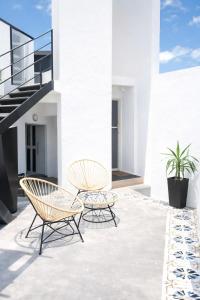two chairs and a table on a patio at Aura Apart in Reconquista