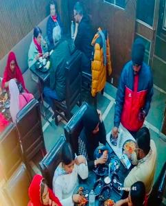 a group of people sitting at a table eating food at Taj 3 Star Hotel Near 200mtr Taj Mahal Agra in Tājganj