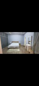 a bedroom with a bed and a table in it at Guest house in Addis Ababa