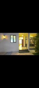 a white house with two windows and a door at Guest house in Addis Ababa