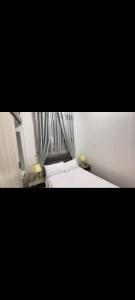 a bedroom with a white bed and a window at Guest house in Addis Ababa +4 photos