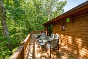 a wooden deck with a table and chairs on it at Cozy Cabin by Railey Vacations in Oakland