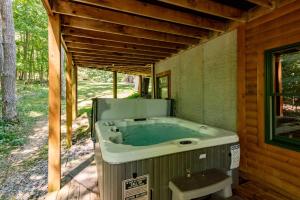 a jacuzzi tub sitting inside of a house at Cozy Cabin by Railey Vacations in Oakland