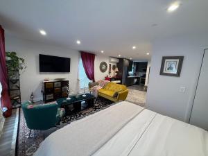 a bedroom with a bed and a living room at Eleni’s Charming Studio in North Beach
