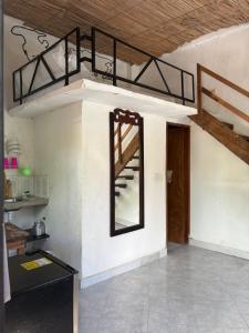 a room with a staircase and a mirror on the wall at Casa chill out in Minca