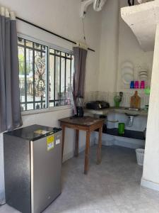 a kitchen with a table and a refrigerator in it at Casa chill out in Minca +25 photos