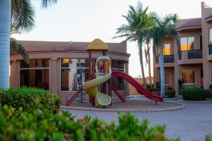 a playground with a slide in front of a building at شاليهات الأحلام لبيوت العطلات in Yanbu