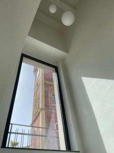 a view of a clock tower through a window at Alsama in Canicattì