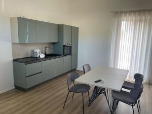 a kitchen with a table and chairs in a room at Alsama in Canicattì