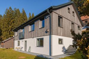 a house clad in wood and white at Almhaus Kloster 38 in Kloster