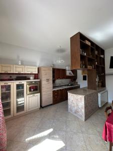 a large kitchen with wooden cabinets and a counter top at La Casa del Corso in Bari Sardo +10 photos