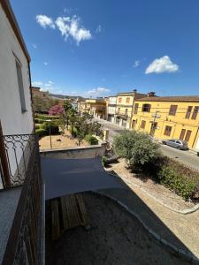 a view of a street from a balcony of a building at La Casa del Corso in Bari Sardo