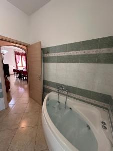 a bathroom with a bath tub in a room at La Casa del Corso in Bari Sardo