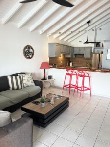 a living room with a couch and a table at PERLE DES ANTILLES in Oyster Pond