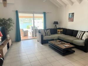 a living room with a couch and a coffee table at PERLE DES ANTILLES in Oyster Pond