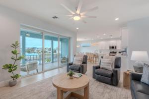 a living room with a couch and chairs and a table at Beach Nuts by Sun Palace Vacations in Fort Myers Beach