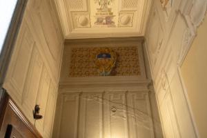 a door with a shield on the top of it at Palazzo Marini in Spoleto