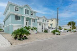a blue and white house on the side of a street at Beach Nuts by Sun Palace Vacations in Fort Myers Beach