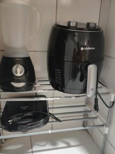 a microwave and a toaster oven on a shelf at Aconchego e tranquilidade é aqui!!!! Te aguardo! in Porto Seguro